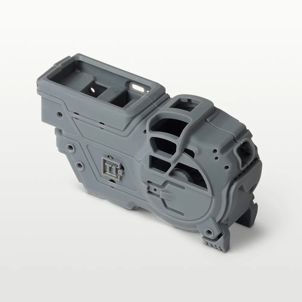 Grey 3D printed mechanical housing with fine surface detail, printed on Form Studio 1